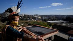 Angoho, an indigenous woman of the Pataxo Ha-ha-hae community, wears a face mask at the Vila Vitoria favela on the outskirts of Belo Horizonte, Brazil
