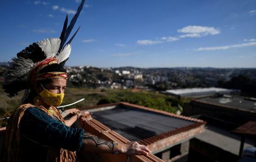 Angoho, an indigenous woman of the Pataxo Ha-ha-hae community, wears a face mask at the Vila Vitoria favela on the outskirts of Belo Horizonte, Brazil