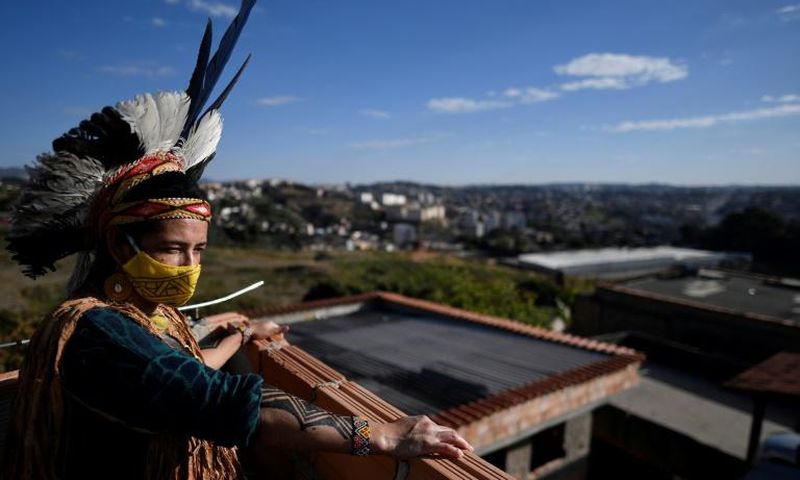 Angoho, an indigenous woman of the Pataxo Ha-ha-hae community, wears a face mask at the Vila Vitoria favela on the outskirts of Belo Horizonte, Brazil