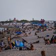 People relax on the beach in Miami Beach, Florida -- a state seeing record numbers of COVID-19 deaths