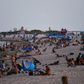 People relax on the beach in Miami Beach, Florida -- a state seeing record numbers of COVID-19 deaths