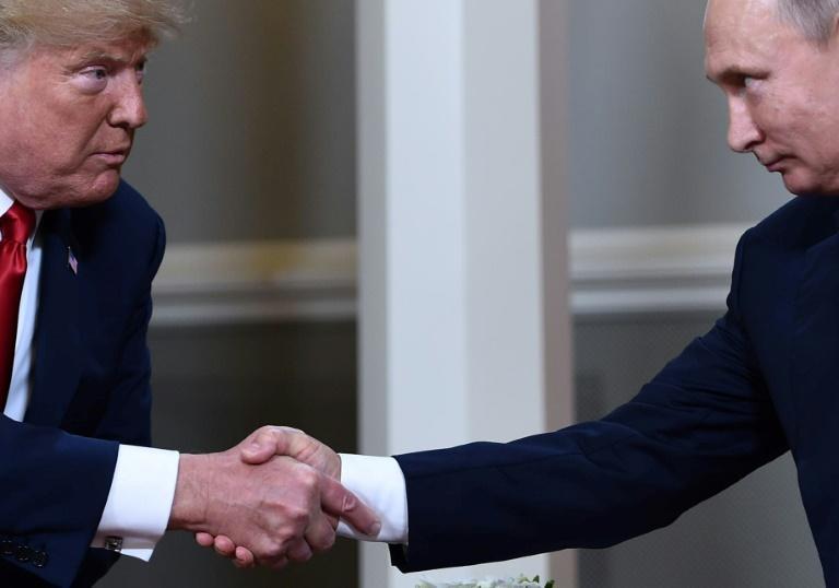 US President Donald Trump and Russian President Vladimir Putin, who are considering a new summit alongside other leaders, shake hands during a July 2018 meeting in Helsinki