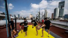 People take part in a Muay Thai martial art class on a roof in Mexico City, on August 15, 2020, as the country stuggles to get in shape amid the coronavirus pandemic