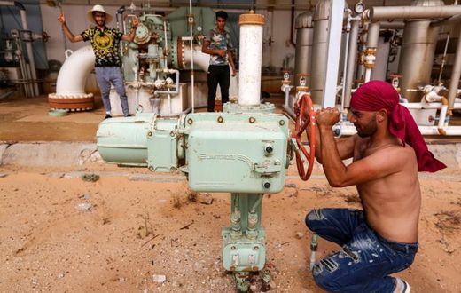 A Tunisian protester shuts down a valve blocking oil production in impoverished southern Tunisia amid growing demands by unemployed youths for jobs and the development of their marginalised region