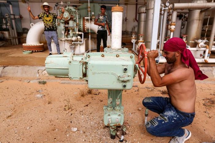 A Tunisian protester shuts down a valve blocking oil production in impoverished southern Tunisia amid growing demands by unemployed youths for jobs and the development of their marginalised region