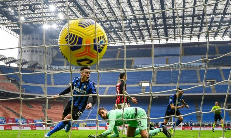 Inter Milan's Argentine forward Lautaro Martinez (L) celebrates after his second goal against AC Milan.