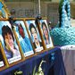 A woman looks at photos of health workers in Puno, Peru who died from Covid-19
