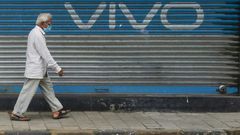 A pedestrian walks past an advert for Chinese mobile phone maker VIVO in Mumbai