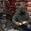 A salesman checks a floating fishing tackle for sale at a his store, after lockdown measures to fight COVID-19 were relaxed in Buenos Aires