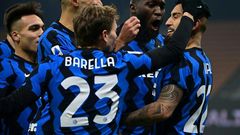 Inter Milan midfielder Arturo Vidal (R) and Nicolo Barella (C) celebrate after scoring against Juventus.