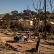 Where the camp's containers once stood, warped tent frames stick out of the rubble like charred skeletons