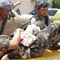 A wounded security staffer is carried by  stretcher to hospital after the Aybak car bomb