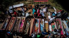 Torajan families unearth deceased relatives and clean their graves in a ritual known as "Manene"