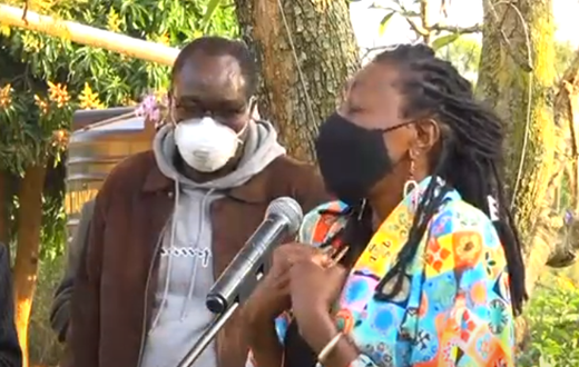 Actress, radio presenter Jacqueline Nyaminde "Wilbroda" addresses mourners during the burial of Charles Bukeko alias "Papa Shirandula"