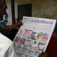 A man reads a newspaper in Colombo a day after Sri Lanka's parliamentary polls saw a turnout of over 70 percent