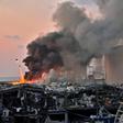 A helicopter pours water onto the fire at the port of Lebanon's capital Beirut