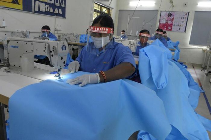 Women from the GMR Varalakshmi Foundation stitch Personal Protective Equipment for frontline coronavirus workers in Hyderabad