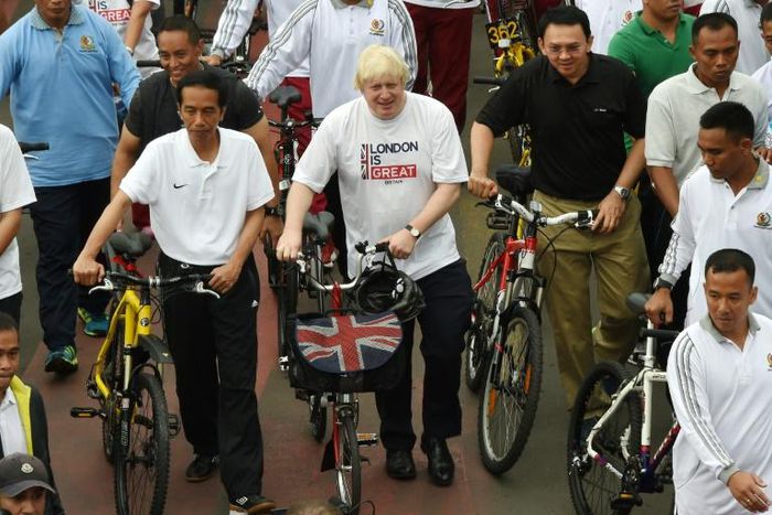 Boris Johnson, seen in his mayor of London days on a visit to Jakarta, says the coronavirus is a 'wake-up call' to the risks of being overweight and junk food advert bans and more biking can help tackle the issue