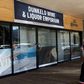 A woman walks past a closed liquor shop in Johannesburg in July 2020
