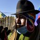 An Amauta, a priest of Bolivia's indigenous Aymara community, blows an instrument during an anti-government march