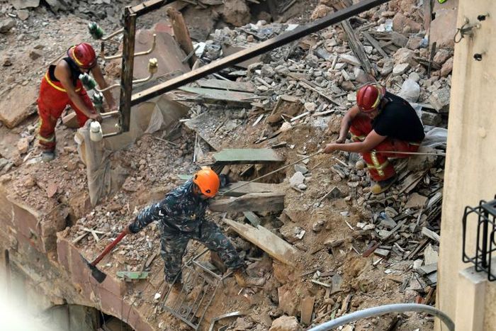 Rescue workers dig through the rubble of a badly damaged building in Lebanon's capital Beirut in search of a possible survivor from a mega-blast at the adjacent port one month ago, after scanners detected a pulse, on September 4, 2020