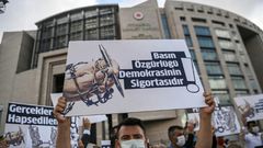 Demonstrators rallied outside the Turkish court with posters calling for press freedom