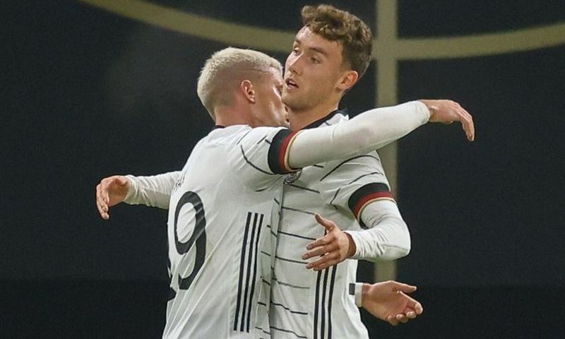 Luca Waldschmidt (R) celebrates scoring Germany's winning goal in Leipzig