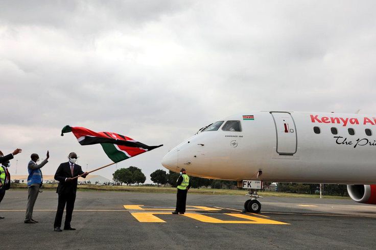 Transport CS James Macharia flags off a Kenya Airways plane during the resumption of local flights