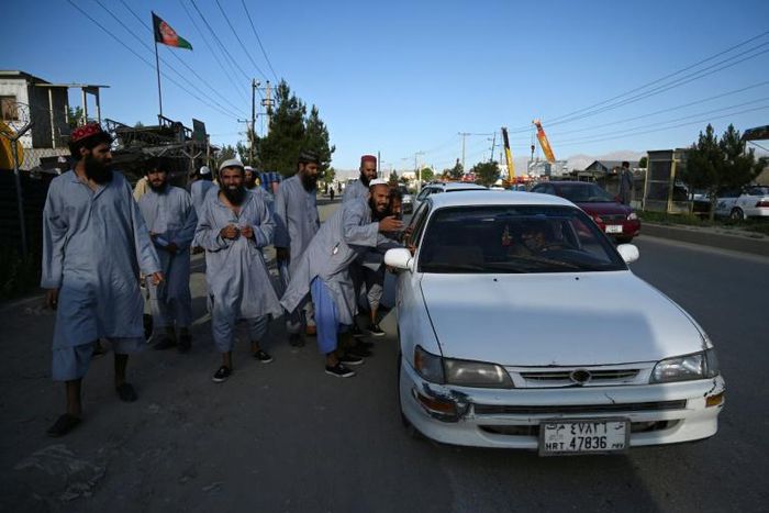 Taliban prisoners stop a local taxi after their release from Afghanistan's Bagram prison