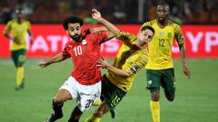 Liverpool and Egypt star Mohamed Salah (L) and Dean Furman of South Africa battle for possession during a 2019 Africa Cup of Nations last-16 clash in Cairo.