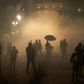 Protesters stand amid tear gas near the federal courthouse in  Portland, Oregon during a rally against police brutality late on July 24, 2020