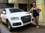Kabi's Mother posing beside her sons car
