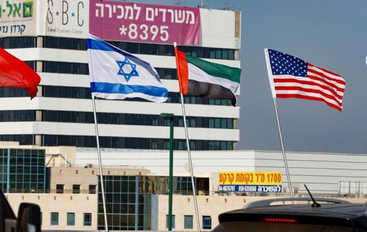The national flags of (L-R) Bahrain, Israel, the United Arab Emirates, and the United States are flown along a road in Israeli resort city of Netanya after the two Gulf countries agreed to normalise ties with the Jewish state