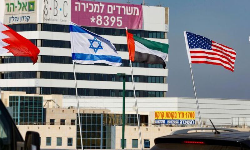The national flags of (L-R) Bahrain, Israel, the United Arab Emirates, and the United States are flown along a road in Israeli resort city of Netanya after the two Gulf countries agreed to normalise ties with the Jewish state