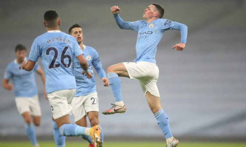 Manchester City midfielder Phil Foden (right) celebrates scoring against Brighton