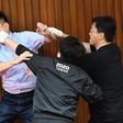 Lu Ming-che of the KMT （left) fights with DPP lawmaker Wu Ping-jui (centre)