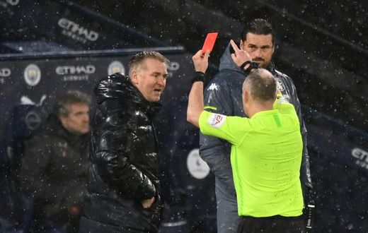 Referee Jon Moss (R) shows a red card to Aston Villa manager Dean Smith (L) during a 2-0 loss away to Manchester City on January 20