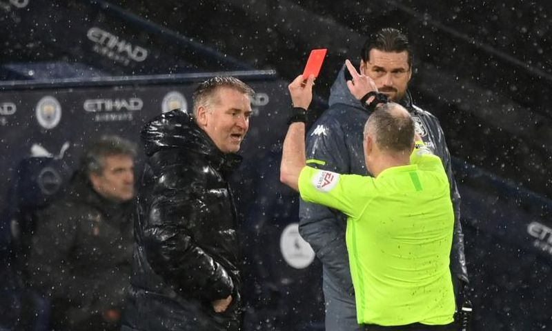 Referee Jon Moss (R) shows a red card to Aston Villa manager Dean Smith (L) during a 2-0 loss away to Manchester City on January 20