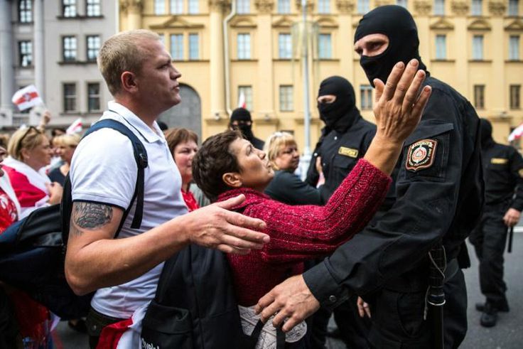 Protesters speak with Belarusian special police officers at a rally against disputed presidential elections results in Minsk on August 30, 2020