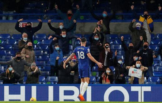 Olivier Giroud celebrates in front of the Chelsea fans, who were back at Stamford Bridge for the first time since March