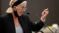 Patti Cosper, the daughter of rape survivor Patricia Murphy shows Joseph James DeAngelo the middle finger after reading a statement on her mother's behalf during the first day of victim impact statements at the Gordon D. Schaber Sacramento County Court...