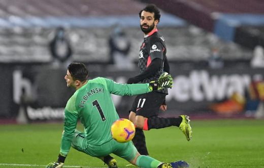 Mohamed Salah (R) scores his second goal for Liverpool against West Ham