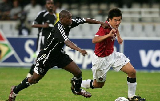 New Chippa United coach Lehlohonolo Seema (L) playing for Orlando Pirates against Manchester United in a tour match