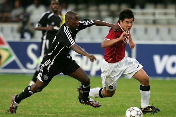 New Chippa United coach Lehlohonolo Seema (L) playing for Orlando Pirates against Manchester United in a tour match