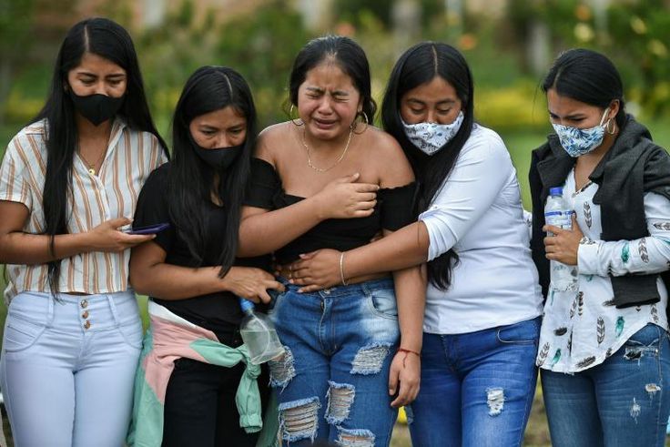 Relatives of Heine Collazos and Esneider Collazos, two of six men massacred by an armed group on August 21 in a rural area Colombia, attend their funeral