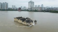 The Guanyinge temple, a 700-year old structure built on a rock in the Yangtze River in Wuhan, is surrounded by flood water