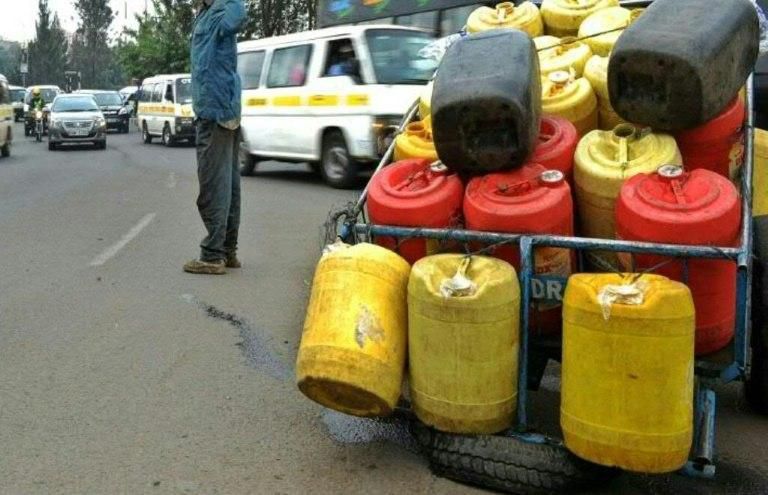 A man hawks water in jerry cans in Nairobi on August 31, 2015 