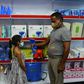 A storekeeper shows to a child a fan-sprinkler used for spraying disinfectant, at a shop selling products against the spread of Covid-19 in Vallabh Vidyanagar, 65km from Ahmedabad, India