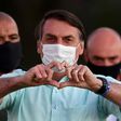Brazilian President Jair Bolsonaro greets supporters in the garden of the Alvorada Palace in Brasilia, on July 22, 2020
