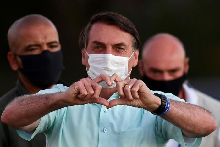 Brazilian President Jair Bolsonaro greets supporters in the garden of the Alvorada Palace in Brasilia, on July 22, 2020
